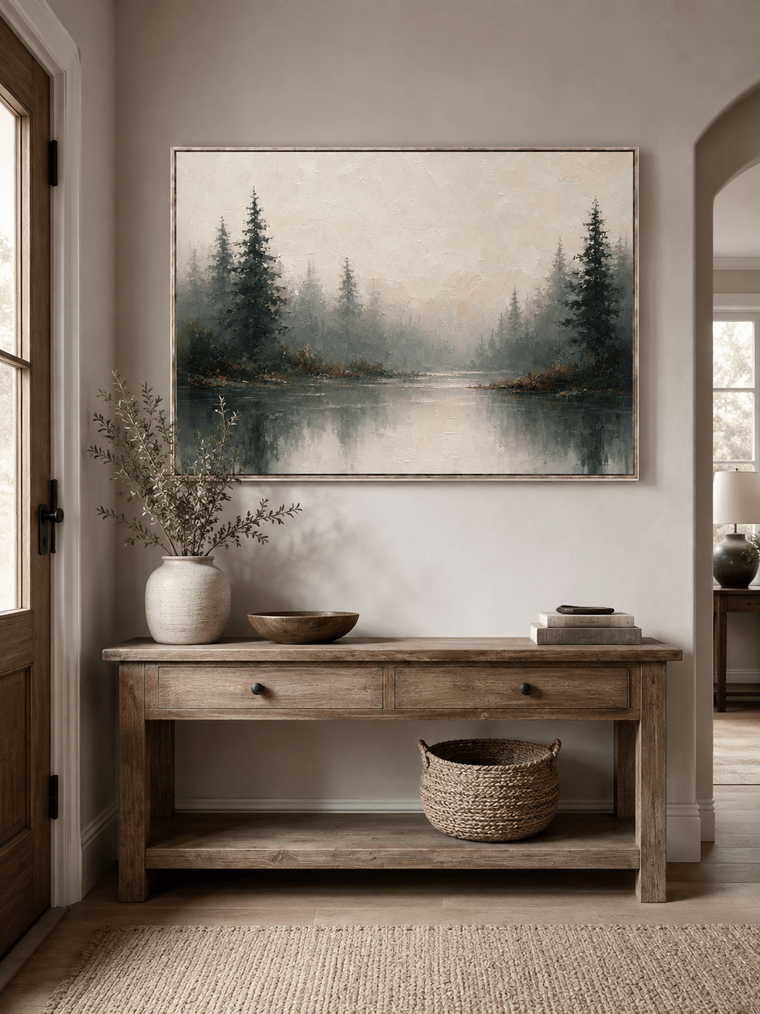 Neutral misty forest painting displayed above a wood console in a contemporary entryway
