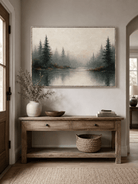 Neutral misty forest painting displayed above a wood console in a contemporary entryway