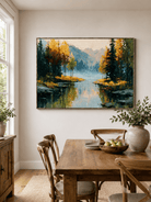 Hand-painted mountain lake wall art with autumn trees displayed in a natural wood dining room