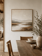 Earth tone textured landscape wall art displayed in a modern open dining room with natural wood furniture