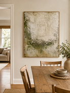 Hand-painted textured green abstract wall art displayed in a modern open-plan dining room