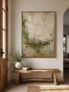 Vertical moss green abstract wall art displayed above a console table in a contemporary entryway
