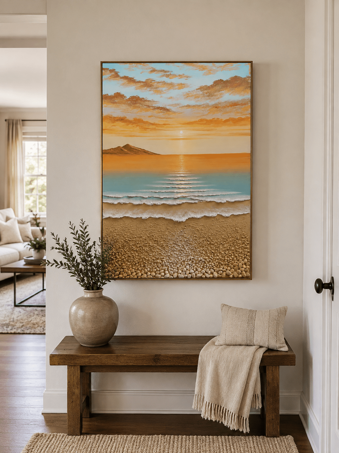 Coastal sunrise wall art above an entryway console in a bright organic modern foyer