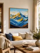 Blue and gold textured mountain painting above a neutral sofa in a contemporary living room