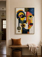 Bold geometric portrait wall art above an entryway console in a modern artistic foyer