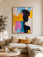 Colorful abstract woman painting above a neutral sofa in a contemporary modern living room