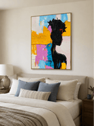Textured female silhouette wall art displayed above a bed in a colorful contemporary bedroom