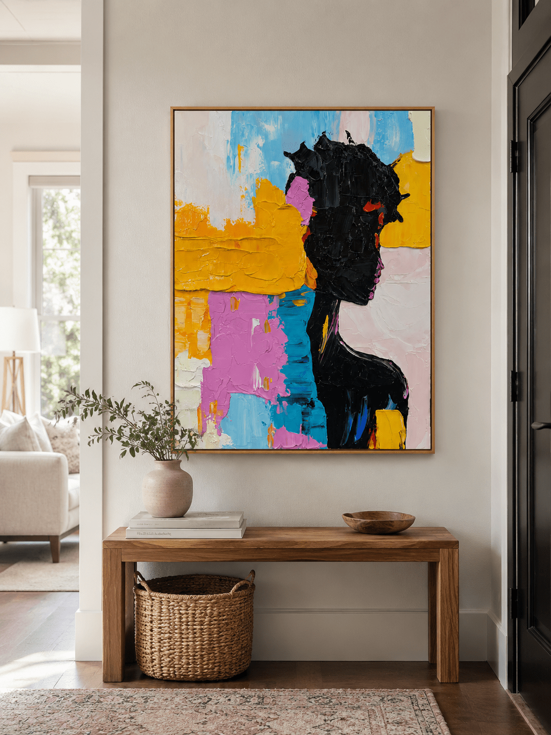 Bold colorful woman wall art above an entryway console in a contemporary artistic foyer