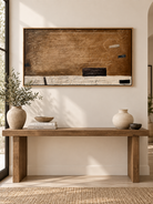 Extra wide brown abstract wall art displayed above a long entryway console in a contemporary neutral interior