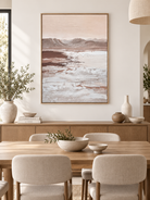 Vertical neutral mountain landscape wall art displayed in an open dining room with walnut and stone furniture