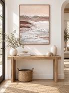 Large vertical textured mountain wall art displayed above an entryway console in a wabi-sabi interior