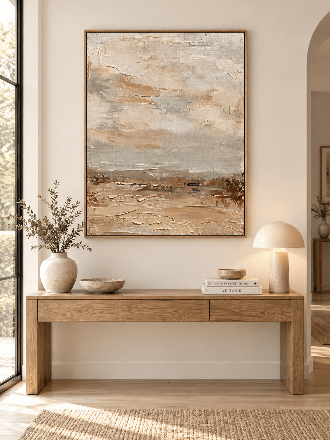 Large vertical beige abstract landscape wall art displayed above an entryway console in a wabi-sabi interior