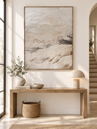 Vertical minimalist textured abstract landscape painting displayed above a console in a neutral modern entryway