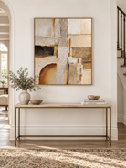 Vertical neutral geometric abstract painting displayed above a console in a Wabi Sabi inspired entryway