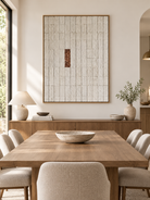 Hand-painted textured geometric wall art displayed in a modern organic open-plan dining room