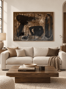 Large horizontal gestural abstract wall art displayed above a sofa in a contemporary living room