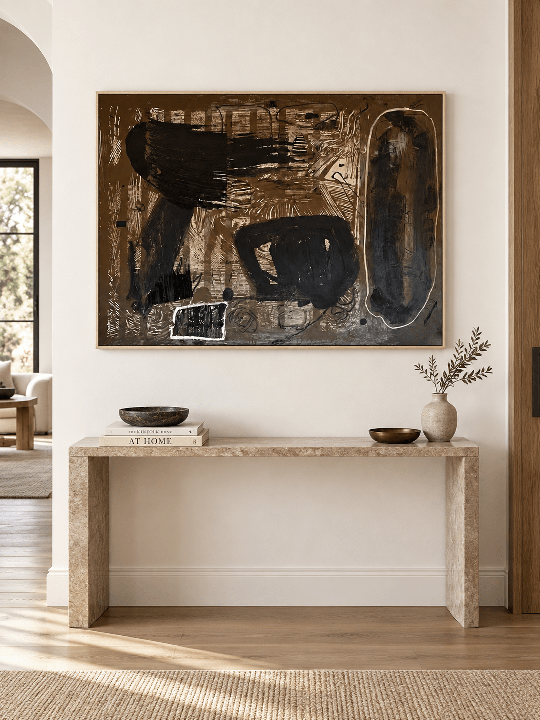 Large horizontal abstract wall art displayed above a console in a modern entryway