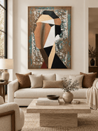 Large geometric abstract woman portrait displayed above a sofa in a contemporary living room