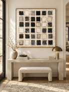 Horizontal black and white textured abstract painting displayed above a console in a modern entryway