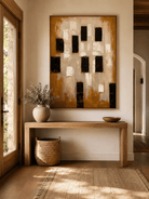 Vertical earth tone textured geometric wall art displayed above an entryway console in a contemporary interior