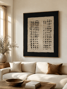 Large black and beige textured wall art displayed above a cream sofa in a Japandi modern living room