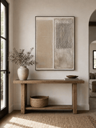 Vertical beige textured wall art displayed above an entryway console in a Japandi-inspired interior