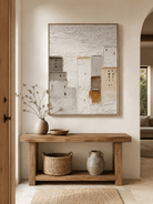 Vertical neutral cityscape wall art displayed above an entryway console in a wabi-sabi modern interior