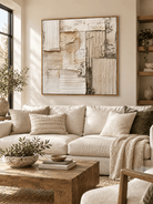 Large neutral textured wall art displayed above a beige sofa in an organic modern living room