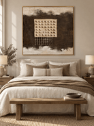 Brown and cream wabi-sabi geometric painting displayed above the bed in a warm neutral bedroom