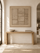 Square beige textured wabi-sabi wall art displayed above an entryway console in a Japandi interior
