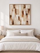 Ivory beige and cognac textured abstract painting displayed above the bed in a warm neutral bedroom