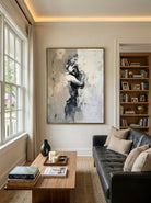 Hand-painted abstract figurative canvas painting featuring a solitary female figure in neutral beige, gray, and black tones with expressive textured brushstrokes for modern bedroom wall decor.