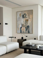 Hand-painted abstract romantic couple canvas painting featuring a seated embrace in neutral beige, gray, ivory, and black tones with textured contemporary brushstrokes.