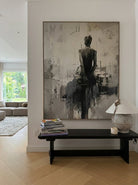 Heavy texture hand-painted abstract ballerina canvas painting in warm gray, cream, and charcoal black by Eleanor Hayes for organic modernist wall decor.