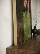 A vertical hand-painted 3D textured art of two women in green dresses with pink impasto flowers on their heads by Eleanor Hayes.