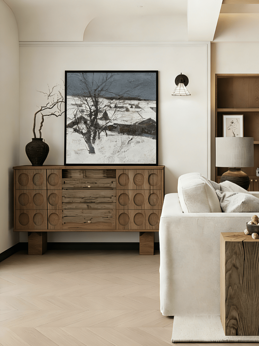 Hand-painted winter landscape oil painting featuring a black tree in a snowy field under a dark grey sky with heavy texture.