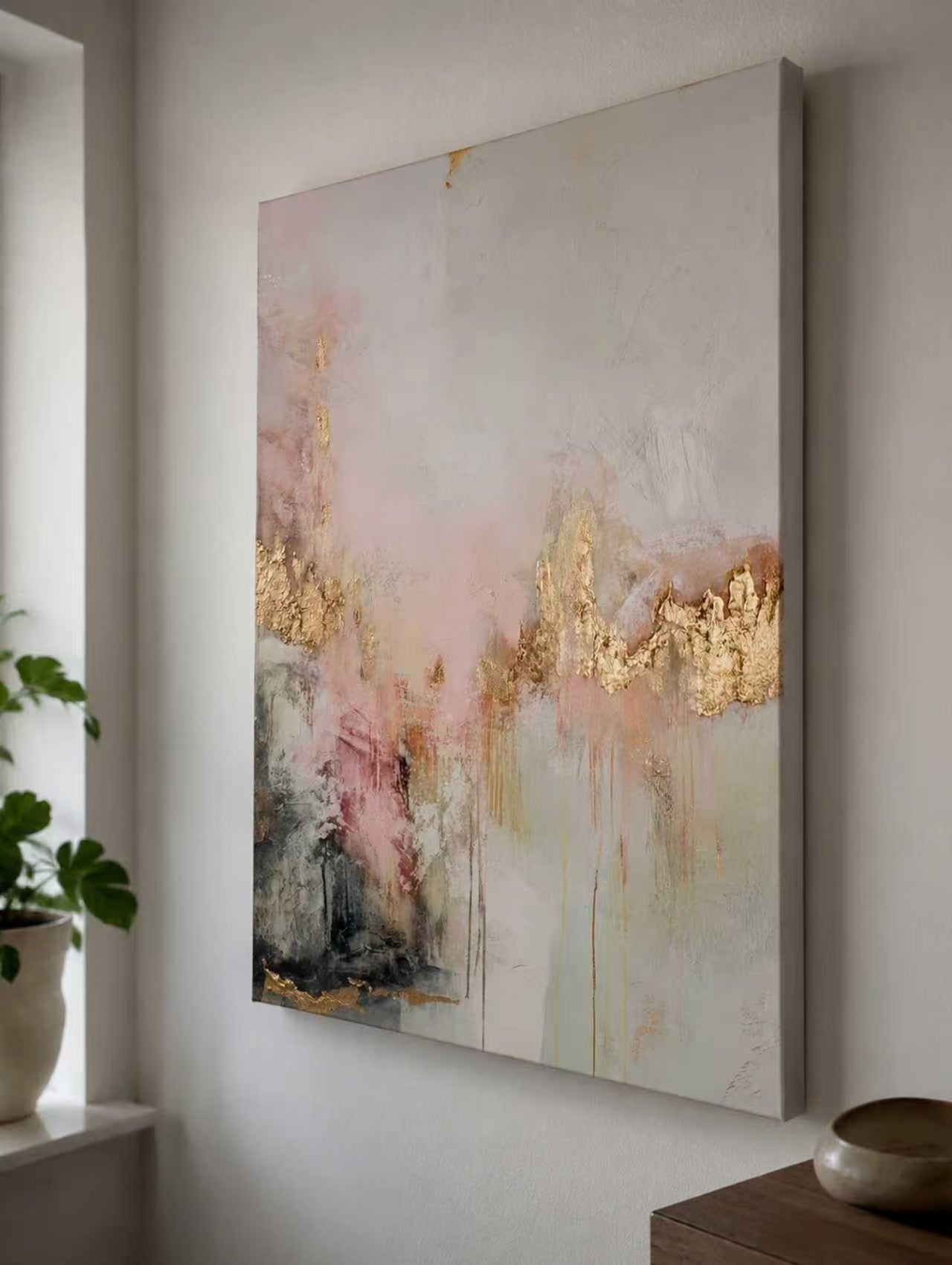Large hand-painted modern abstract canvas painting with 3D textured gold leaf and blush pink brushstrokes by Evelyn Li for luxury master bedroom wall decor.
