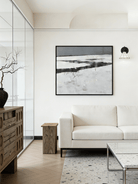 hand-painted abstract oil painting showing a dark winter river winding through a white snowfield in a minimalist style.