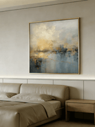 Large square hand-painted impressionist painting of a golden sun reflecting on a blue sea with heavy impasto texture by Evelyn Li in a modern living room.
