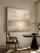 Large square hand-painted gold and white abstract painting with metallic drip texture by Evelyn Li in a luxury living room setting.