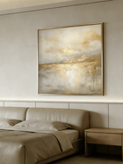 Large square hand-painted gold and white abstract painting with metallic drip texture by Evelyn Li in a luxury living room setting.