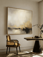 Large square hand-painted abstract painting with heavy 3D gold texture and black drip effect by Evelyn Li in a modern minimalist living room.