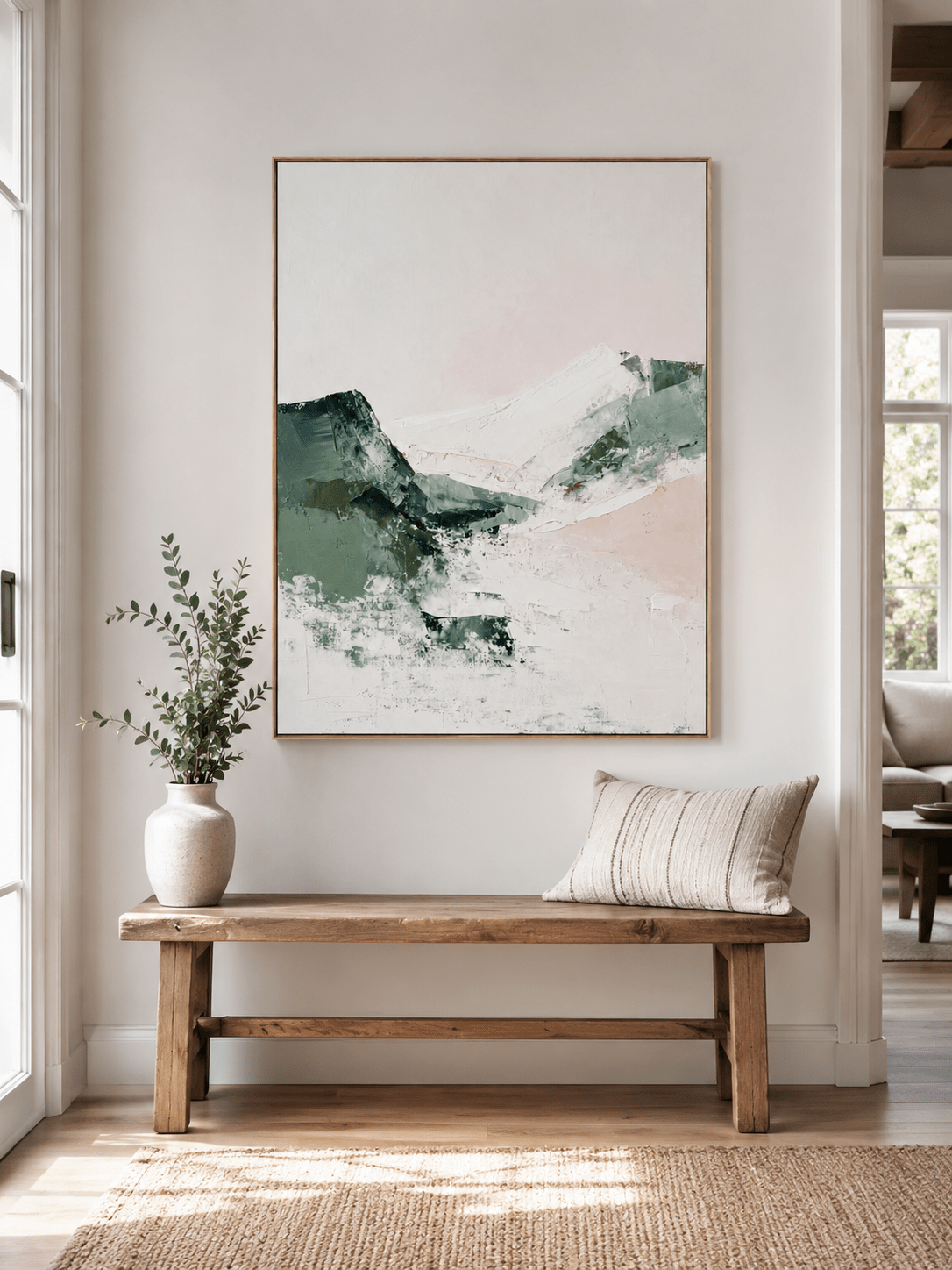 Textured mountain wall art above an entryway console in a minimalist organic modern foyer