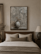 Textured ceramic vase wall art displayed above a bed in a warm Japandi bedroom