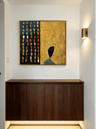 Large 3D textured abstract painting by Eliot Vermeer featuring mustard yellow and navy blue thick paint on canvas in a modern living room.