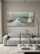 Large horizontal grey and taupe textured impasto canvas art displayed above a modern neutral sofa