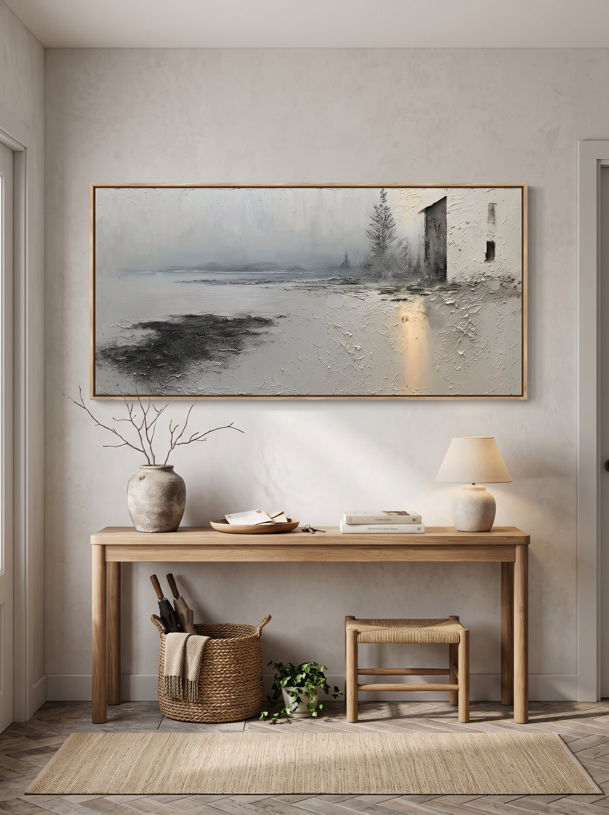 Rustic coastal house canvas painting with golden light reflection above entryway console table