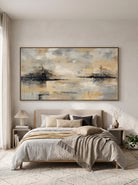 Calming neutral misty forest and lake landscape artwork by Evelyn Li hanging above bed in serene bedroom
