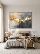 Moody blue and shimmering gold leaf artwork by Evelyn Li hanging above bed in contemporary master bedroom
