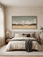 Snowy mountain wall art in sage gray, beige and ivory tones displayed above a bed in a calm modern bedroom.
